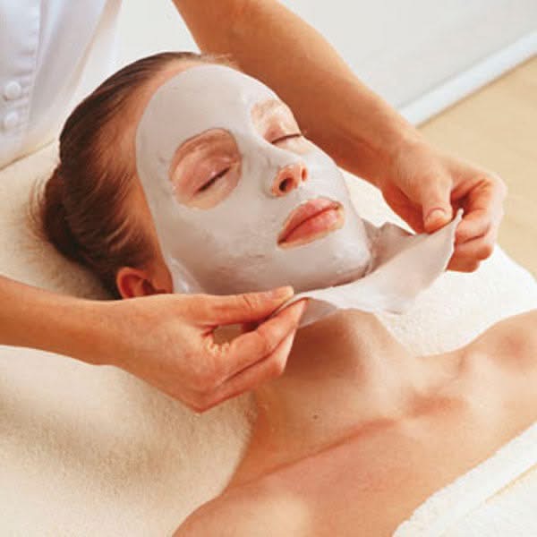 A women's face getting a facial treatment,
