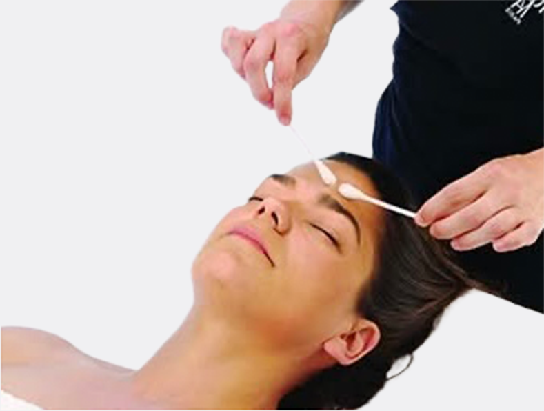 Woman's face getting a facial treatment.